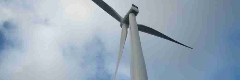 A Siemens wind turbine against a cloudy sky during an insurance inspection